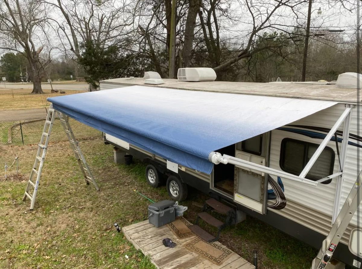 Fresh new blue and white awning installed on the Springdale camper