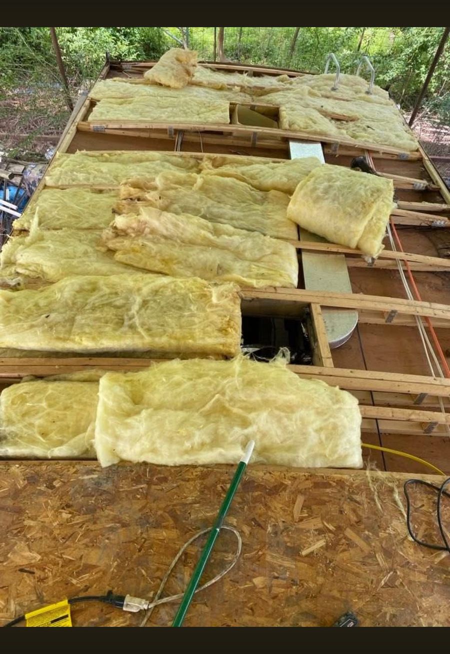 RV roof opened up showing rotten wood and old insulation